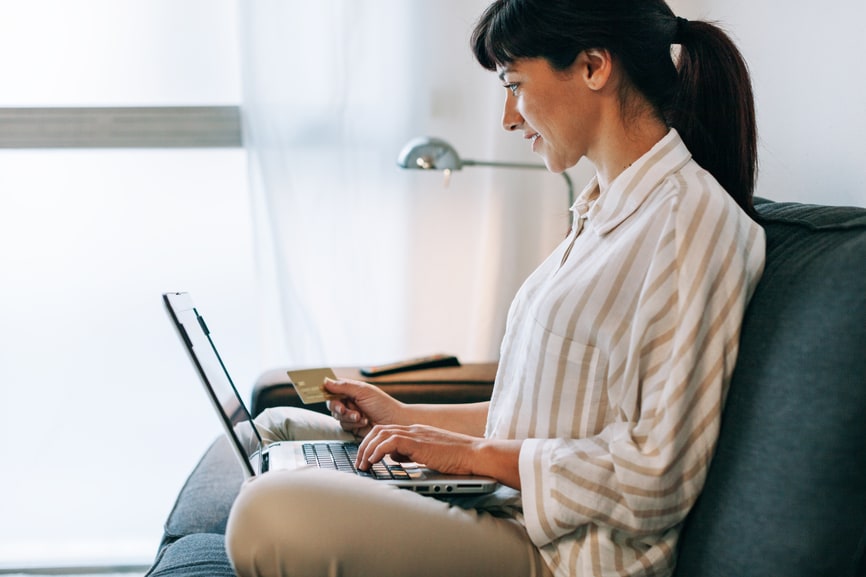 Woman using a credit card on a laptop