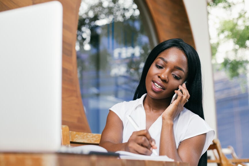 Woman talking on the phone and and amending her tax return.