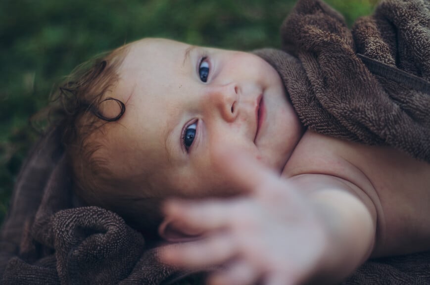 Smiling baby reaching for the camera