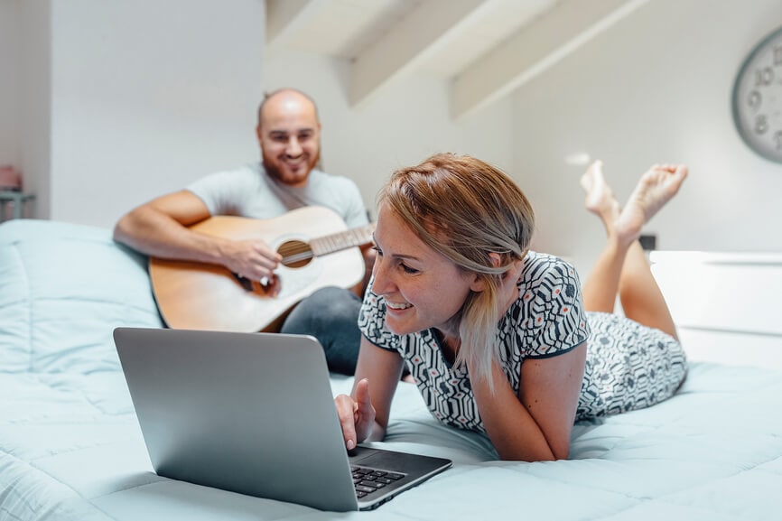 Couple relaxing together and checking state tax deadlines.