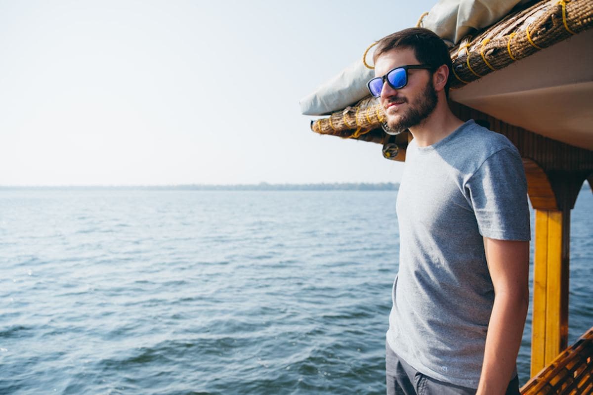 person looking at ocean from a house boat