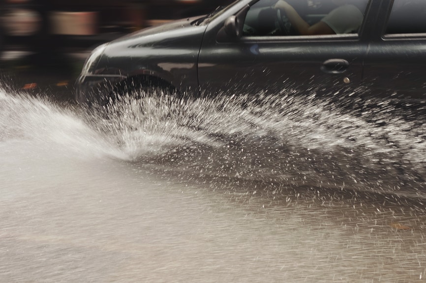 Car driving through flooded area