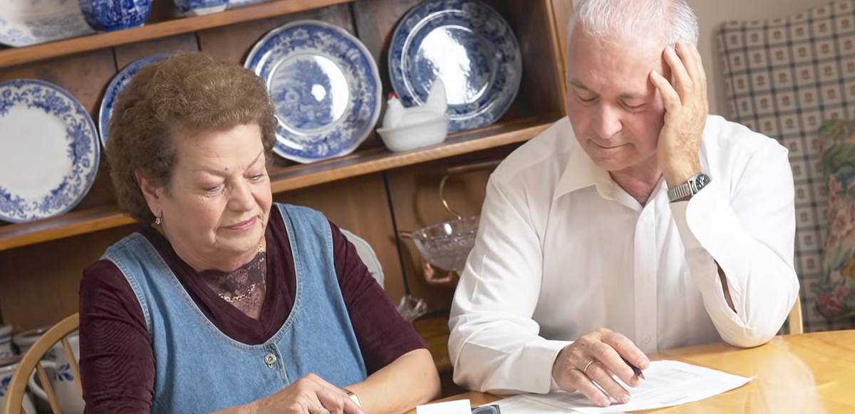 senior couple looking at tax forms
