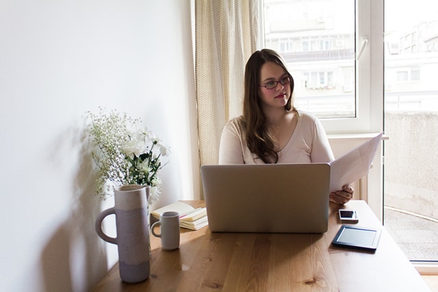 Person reviewing documents at table