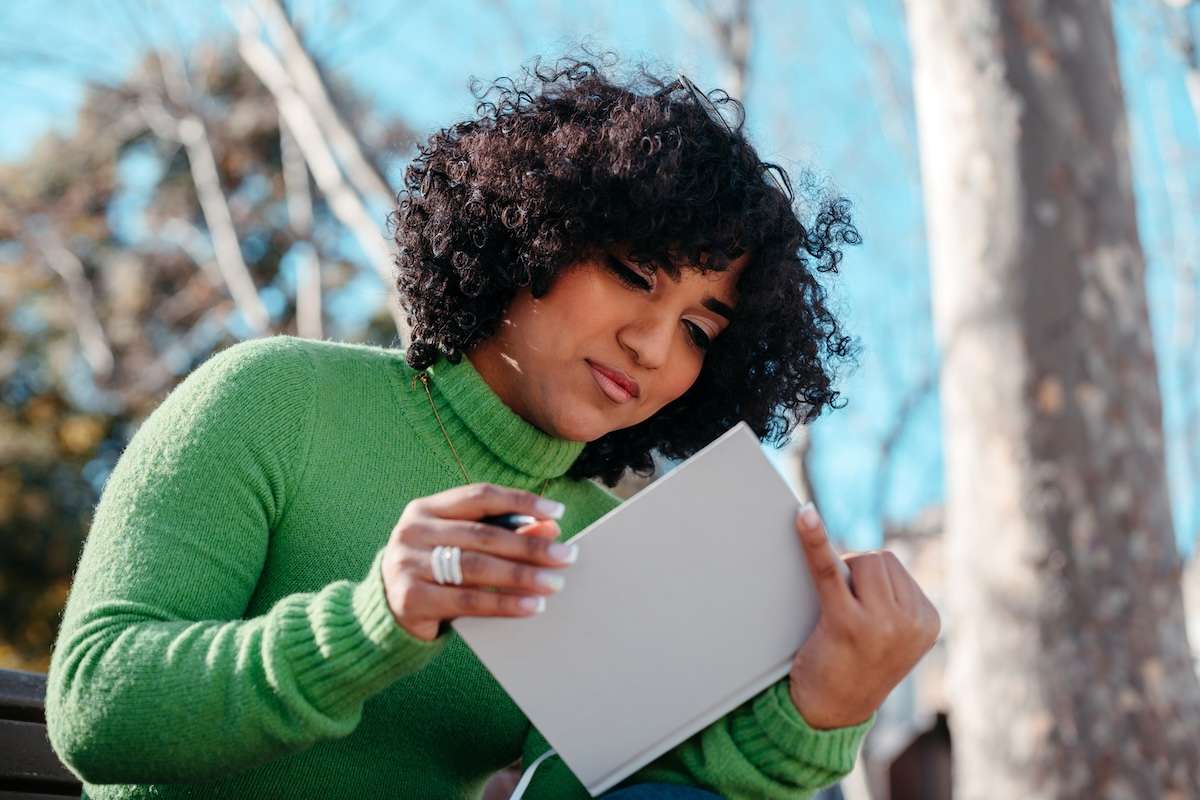 Person reading a book outside