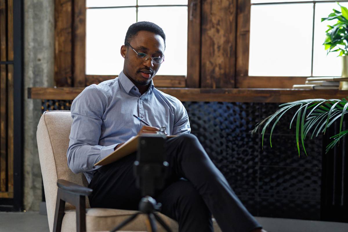 Person seated in chair reading