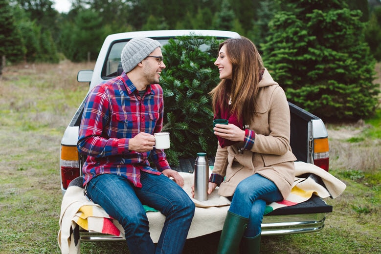 Couple sitting on back of truck