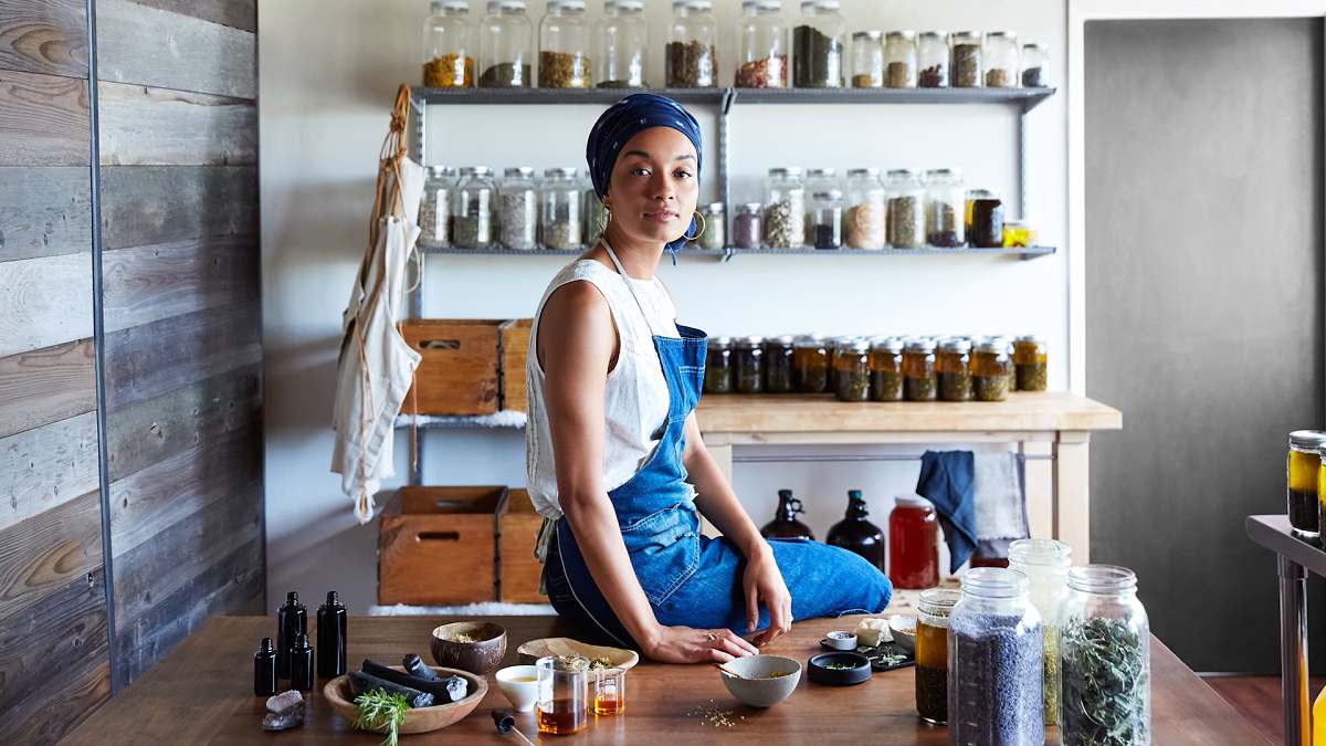 female entreprenuer sitting on work bench