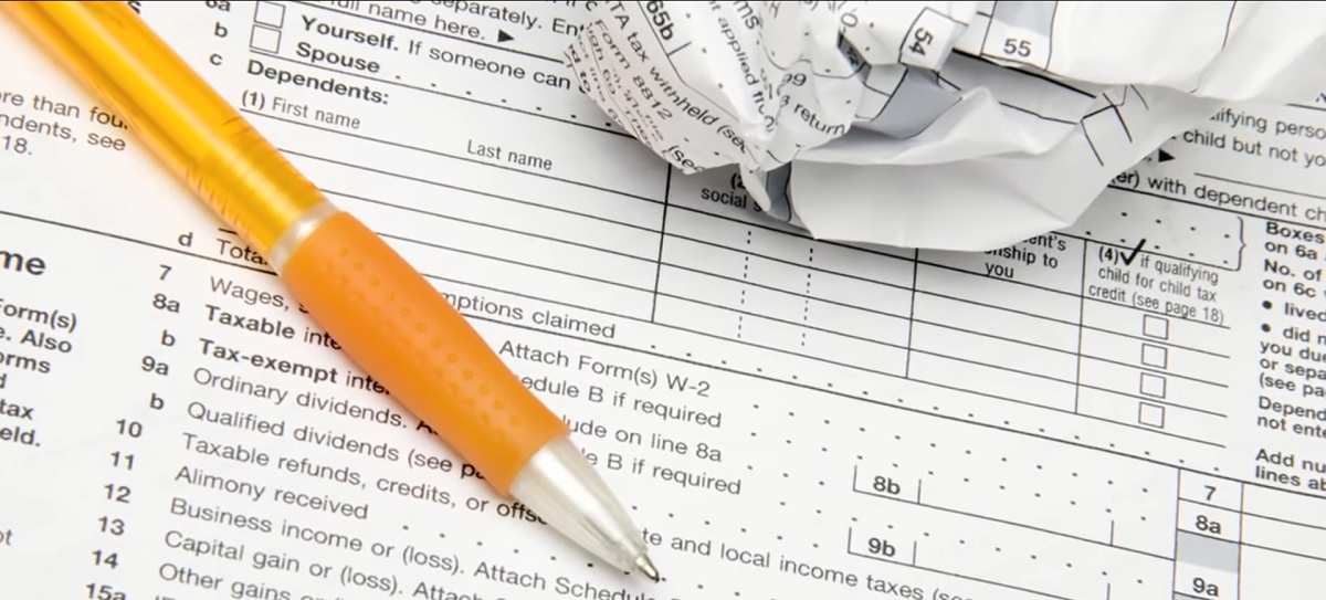 mechanical pencil lying on top of tax form