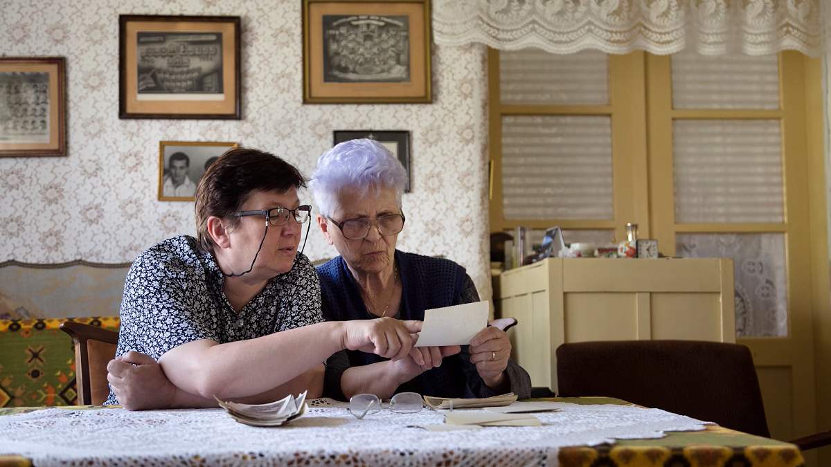 two senior women reviewing documents