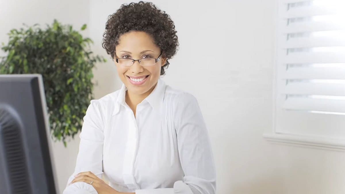 smiling woman at desk in home office