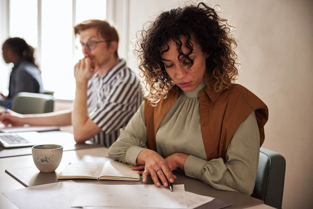 Young businesswoman reading paperwork in a modern office