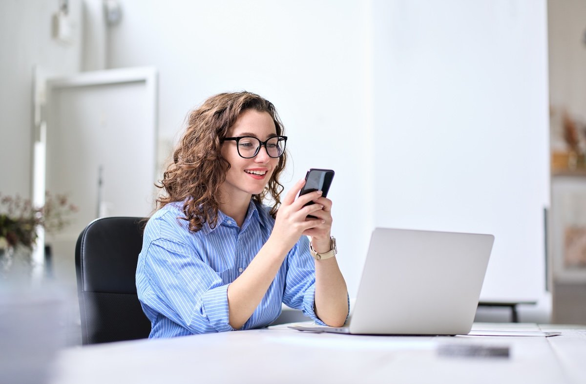 A person sitting at a table with a laptop.