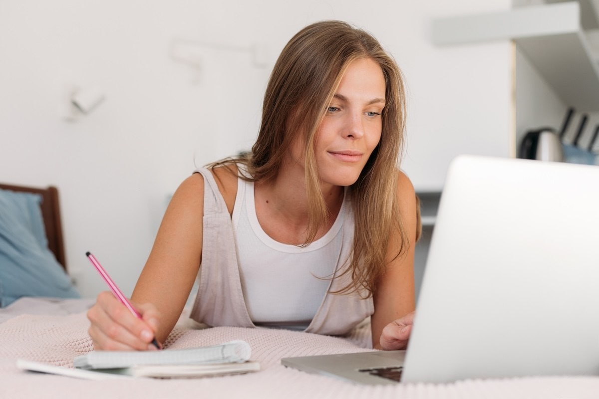 A person sitting at a desk with a laptop.