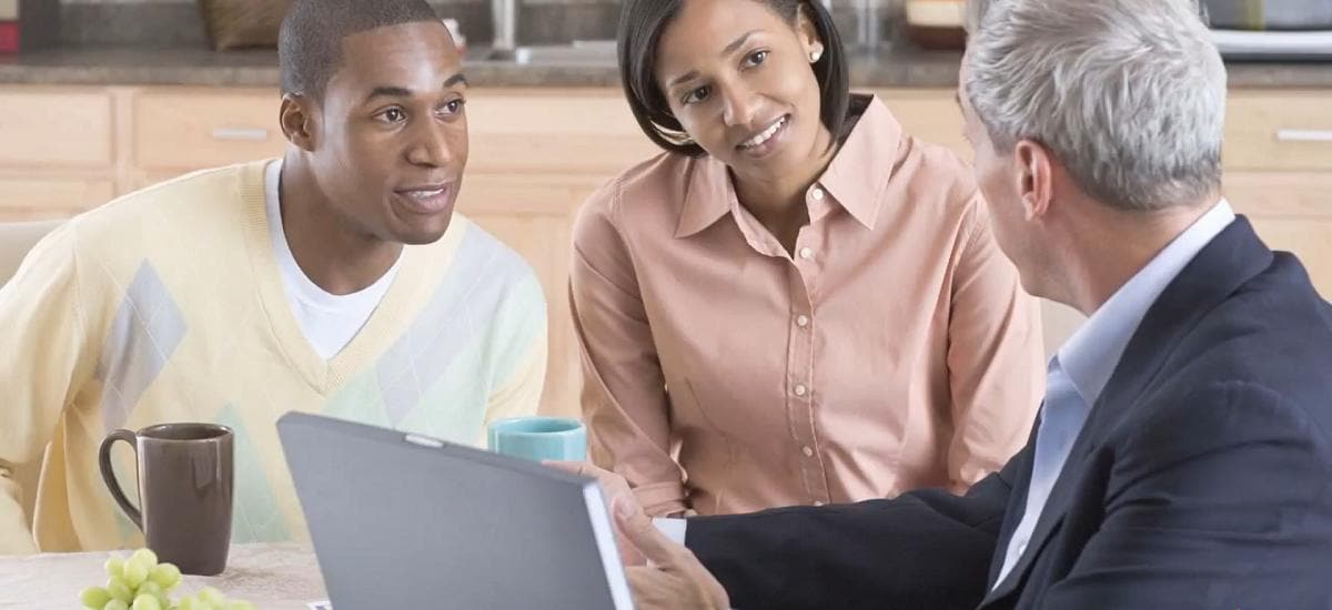 young couple speaking with mature man