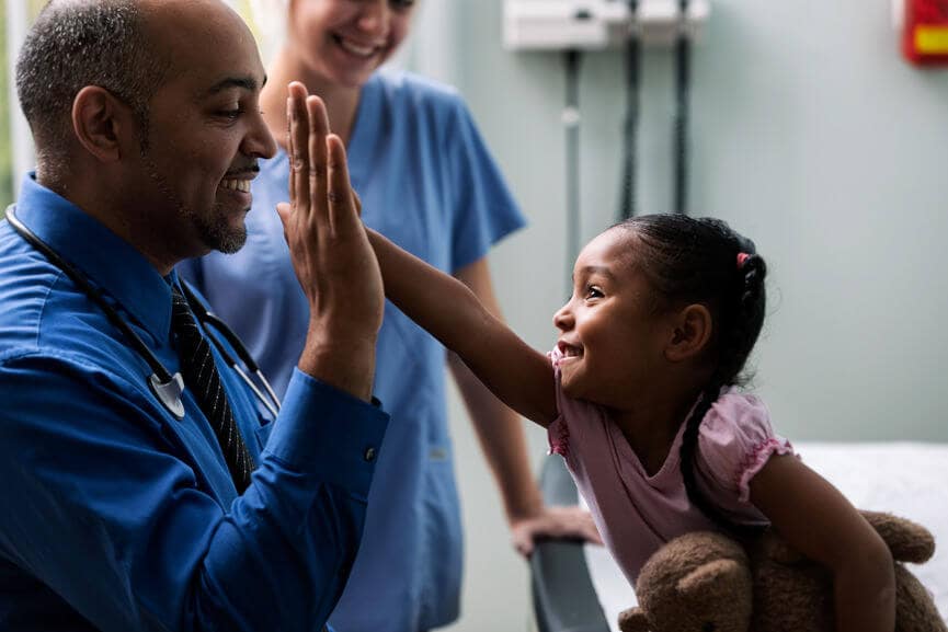 doctor giving a child patient a high five