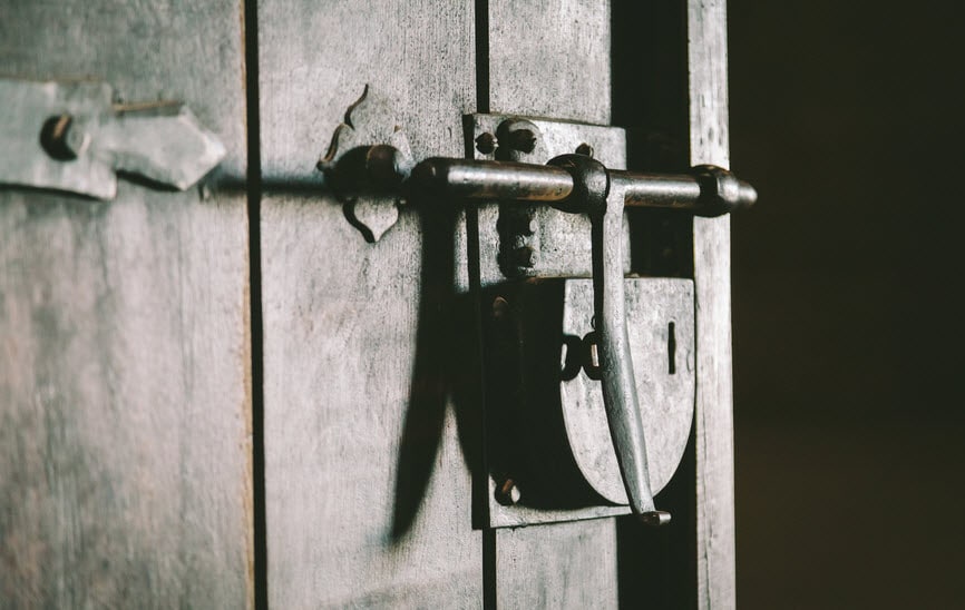 Medieval padlock on wooden door