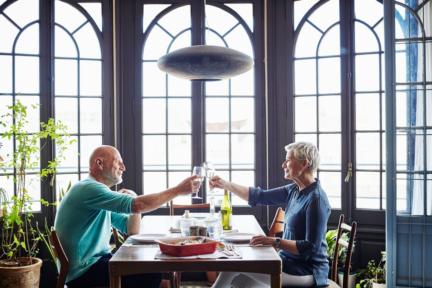 Senior couple toasting at dinner