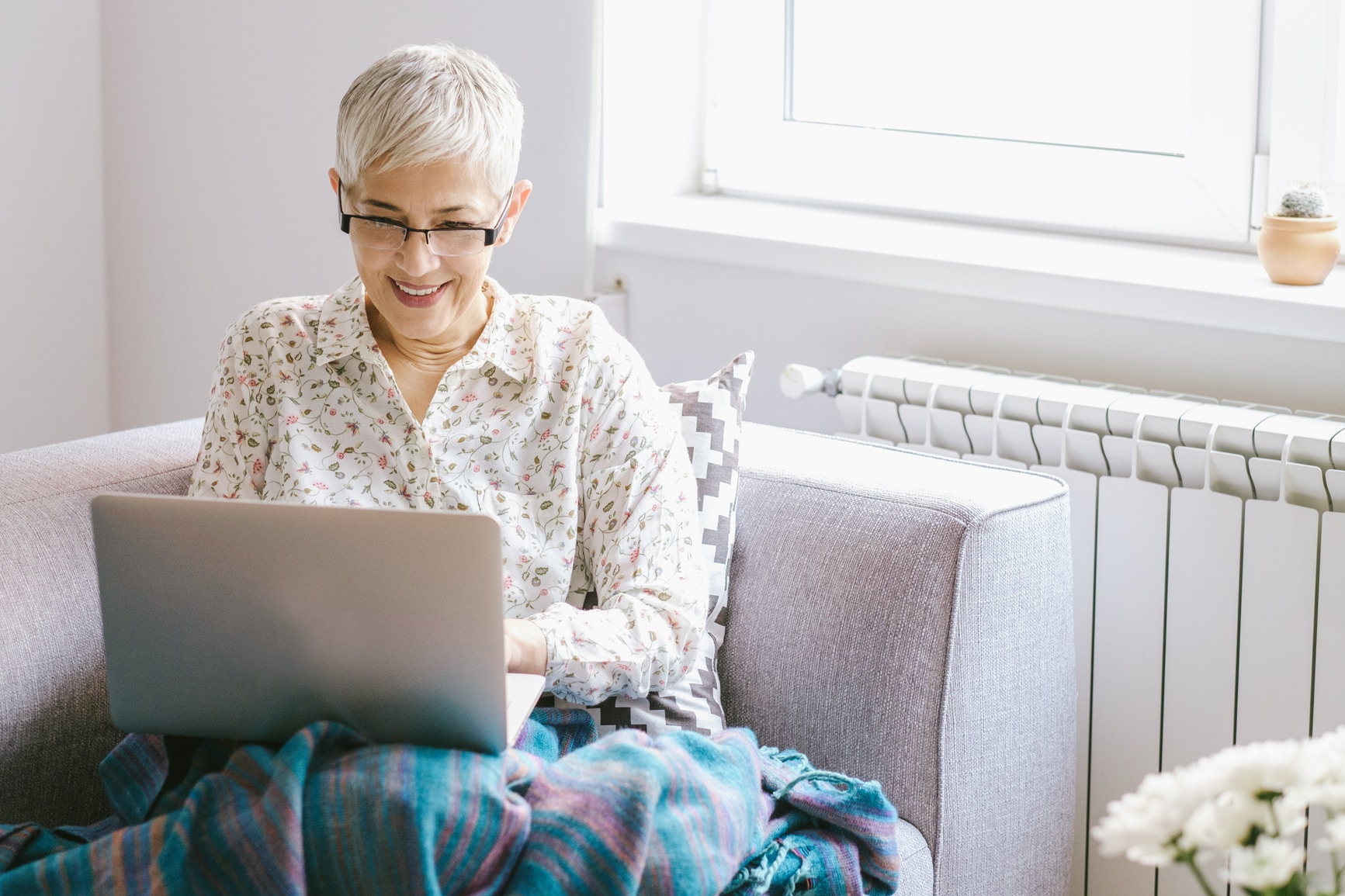 Senior woman using laptop on the couch