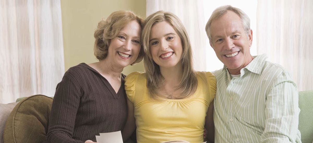 smiling parents and teenage daughter