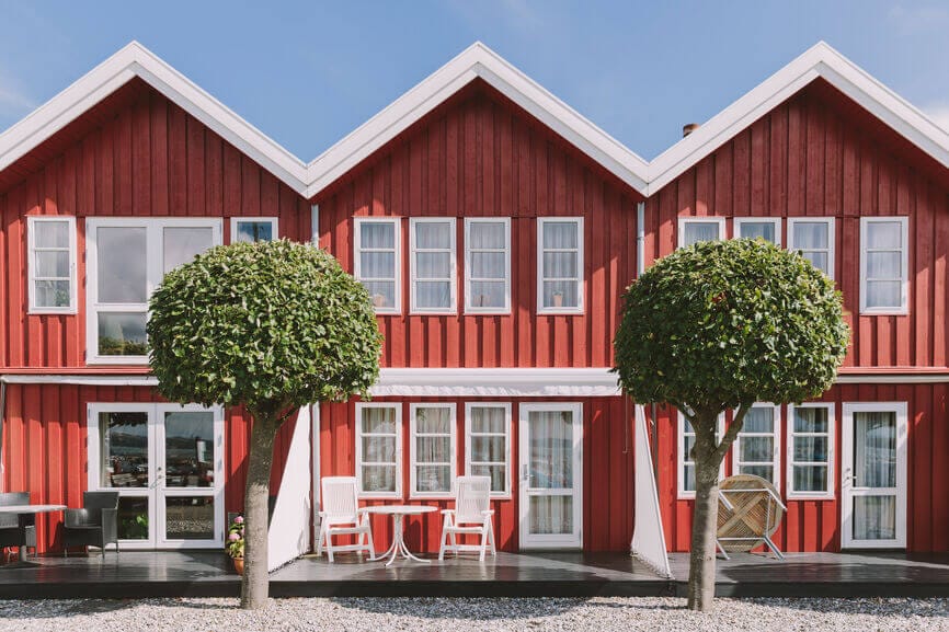 three red and white wooden summer houses