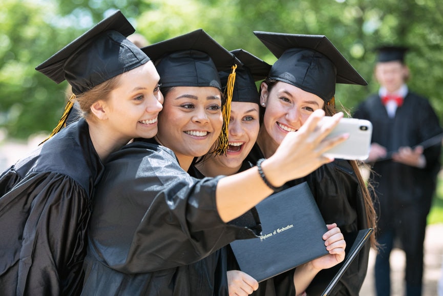 Multi-ethnic group college graduates taking a selfie