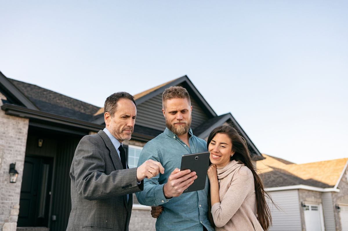 Real estate agent consults with young couple