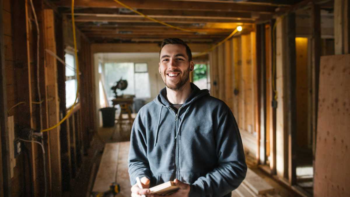Smiling young male carpenter at a work site