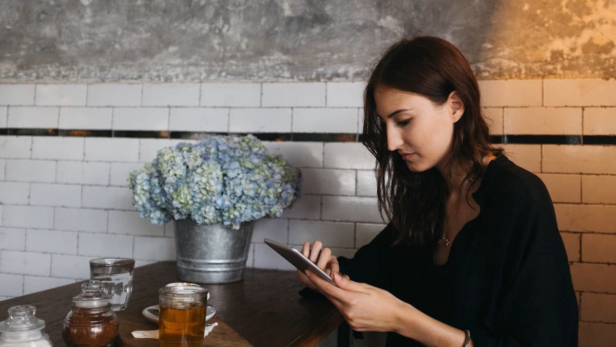 a young woman using a mobile phone in a café 