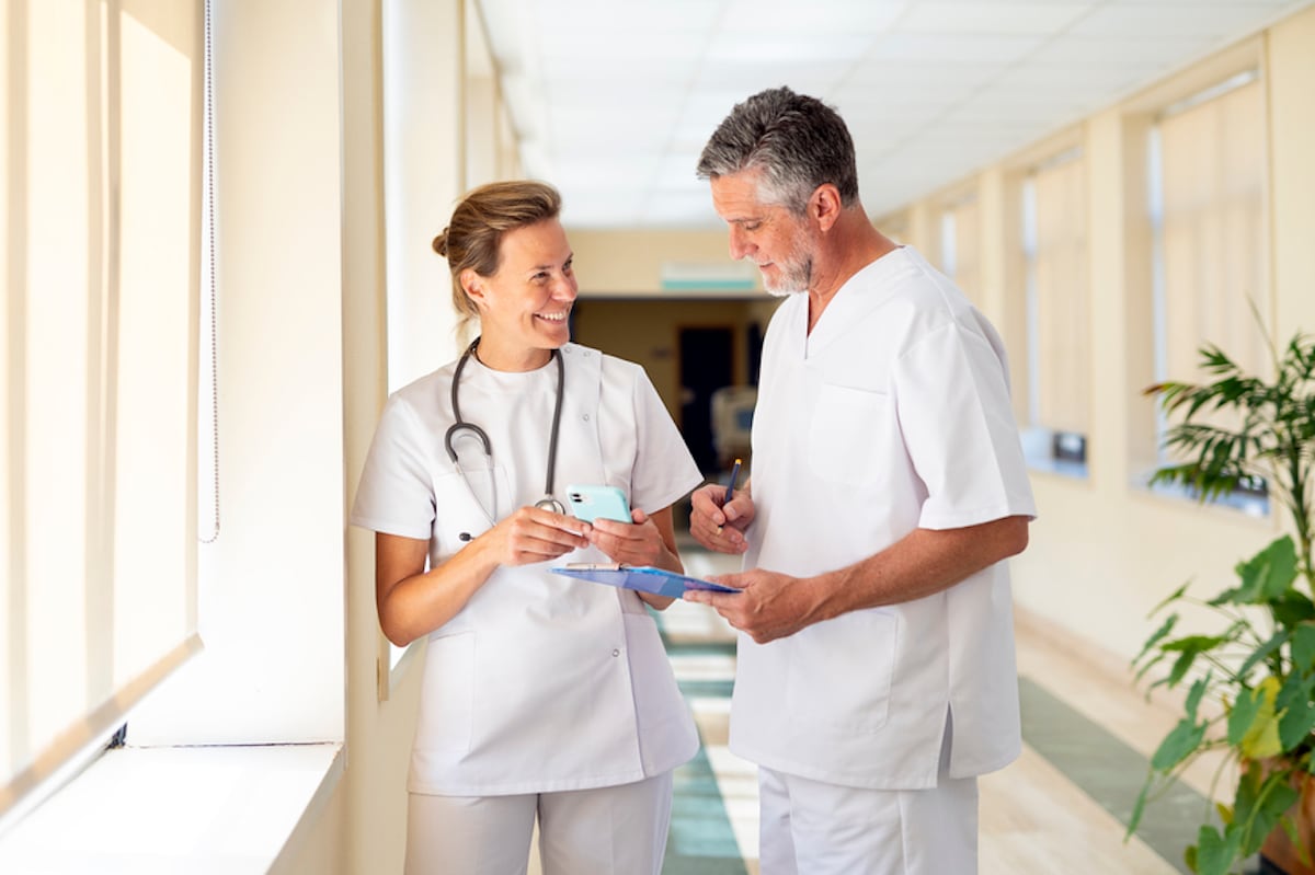 A doctor and nurse talking to each other