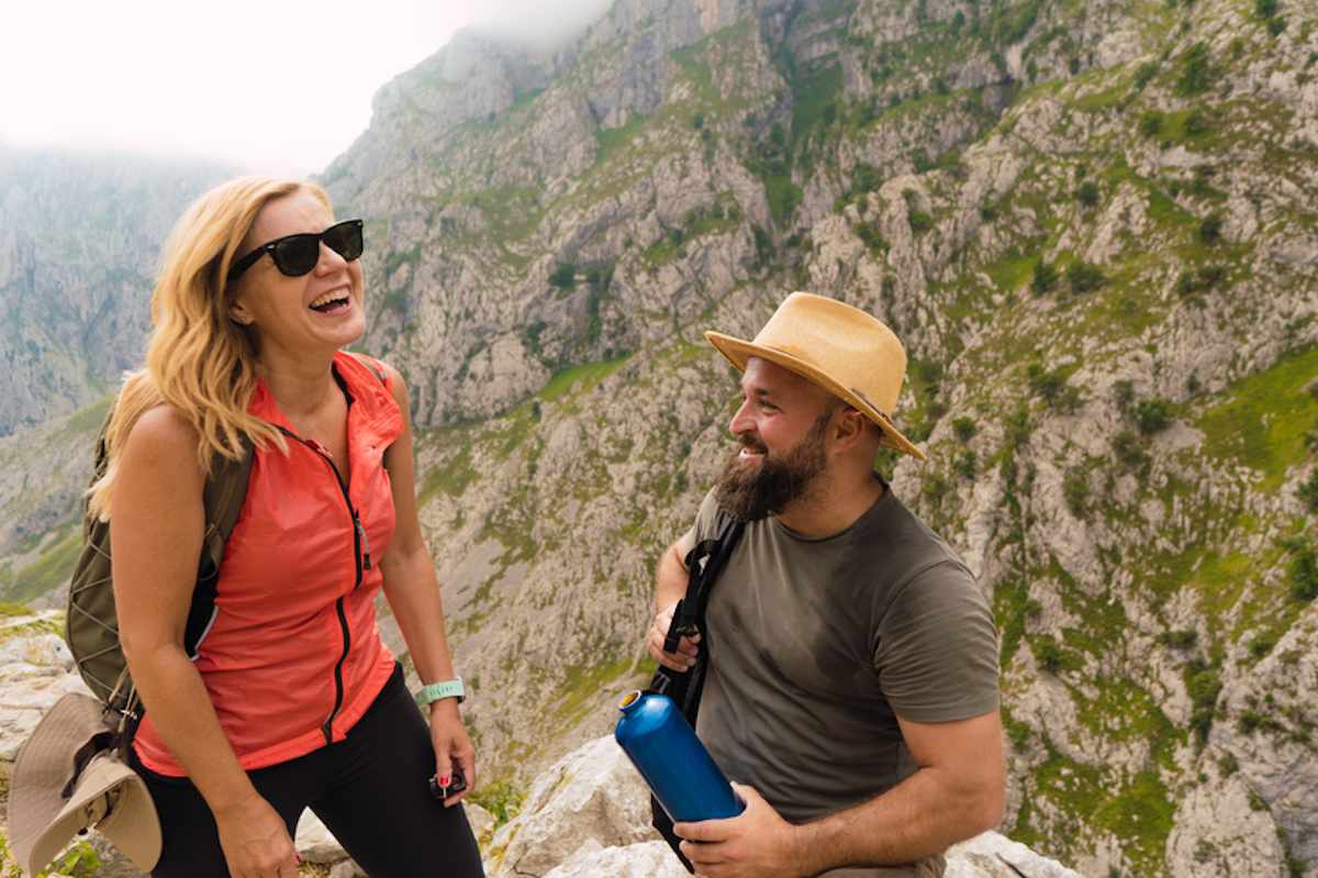 Couple pauses on hike in the mountains