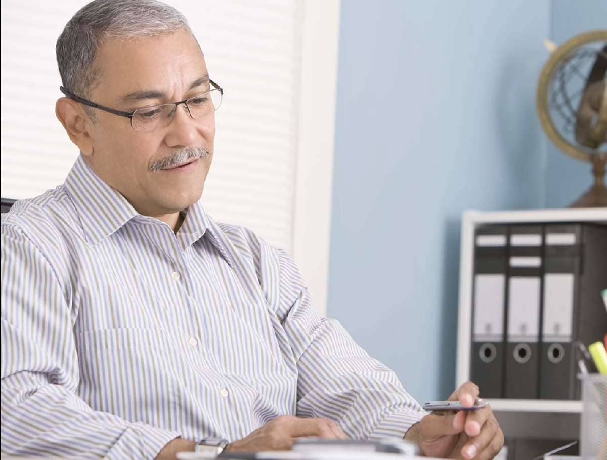 mature man at desk reviewing documents
