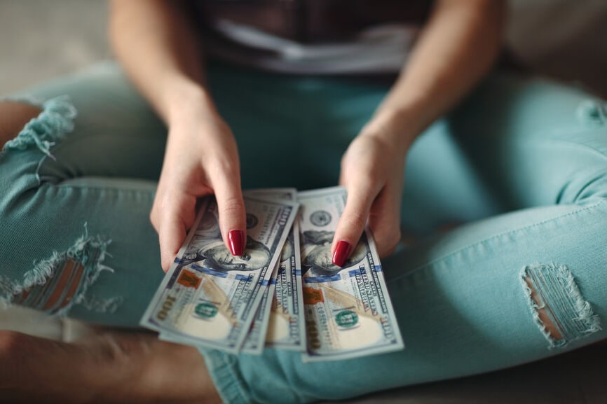 Closeup of woman hands counting new 100 US dollar banknotes