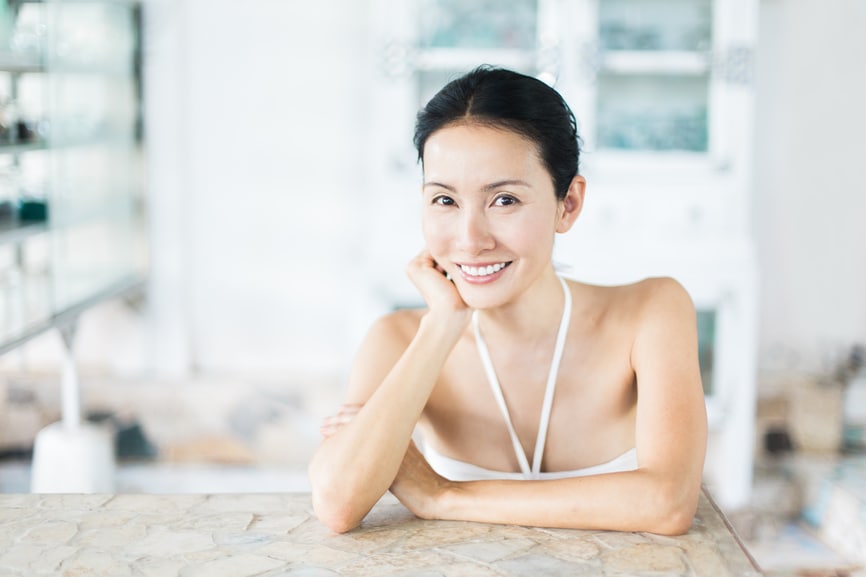 Woman smiling at a table