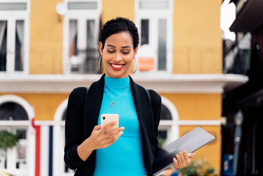 Modern business woman checking her investments and investing apps on her smart phone.