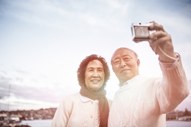 Couple taking a landscape photo of themselves