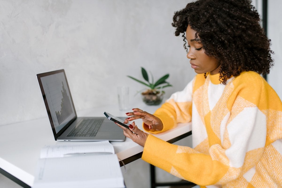 A person sitting at a desk with a laptop computer.