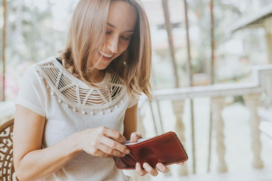 woman reaching into her wallet