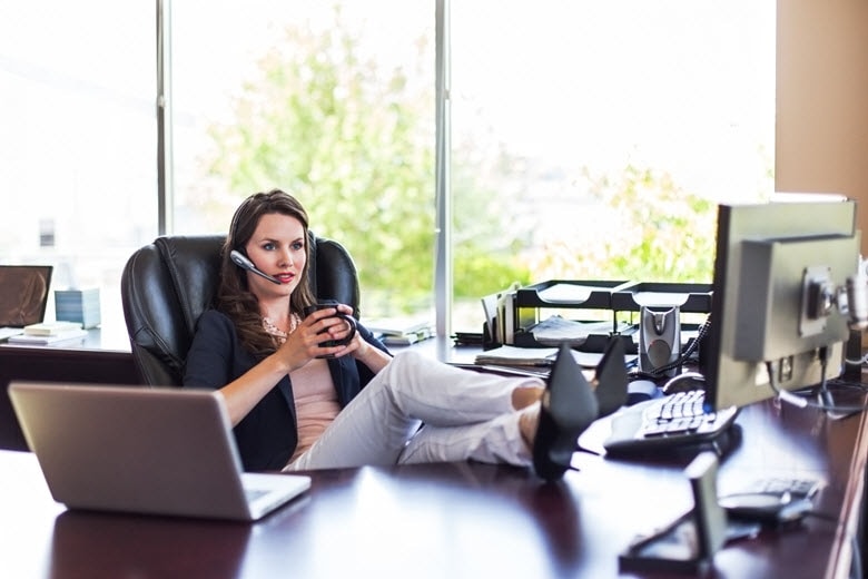 Woman with her feet up on the desk