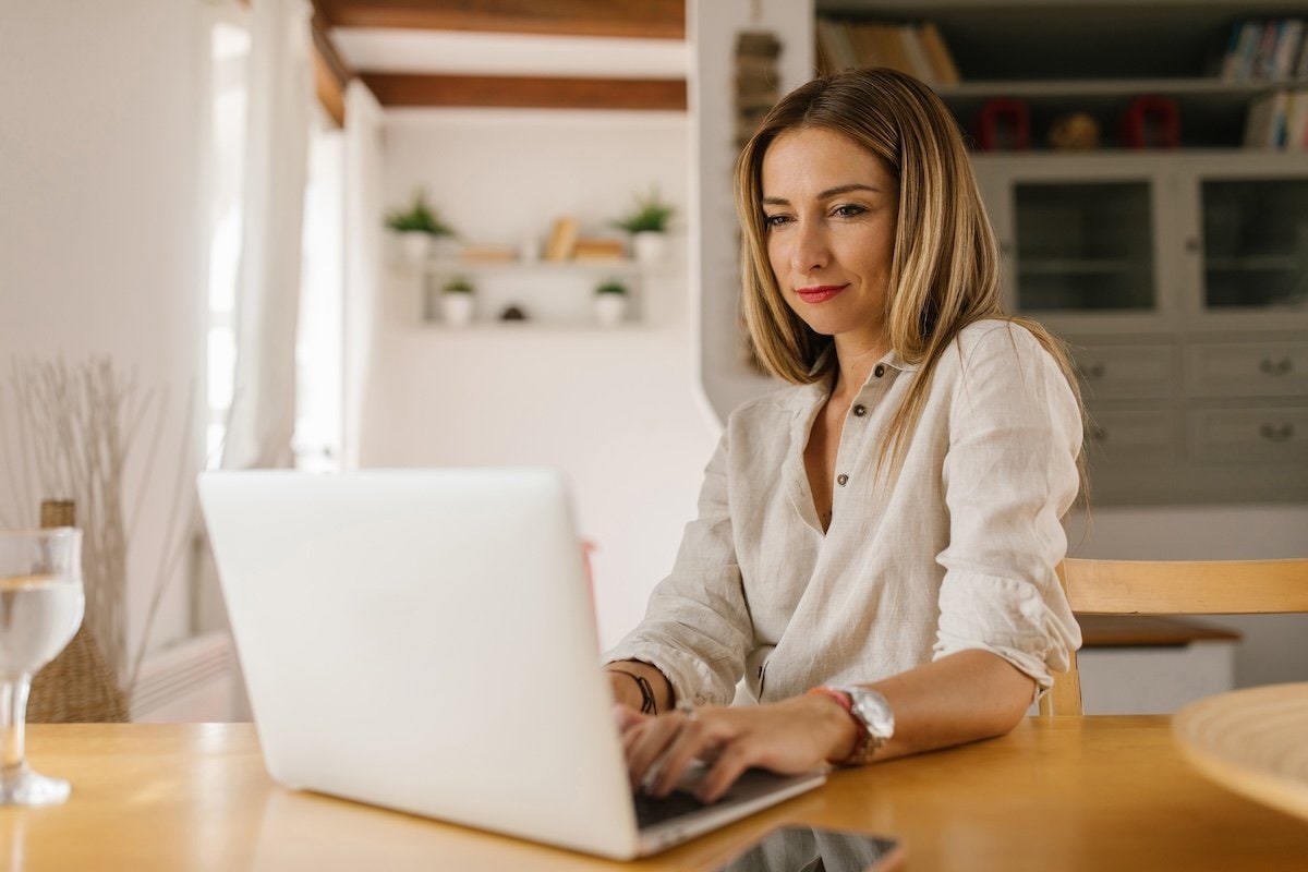 A person sitting at a desk with a laptop.