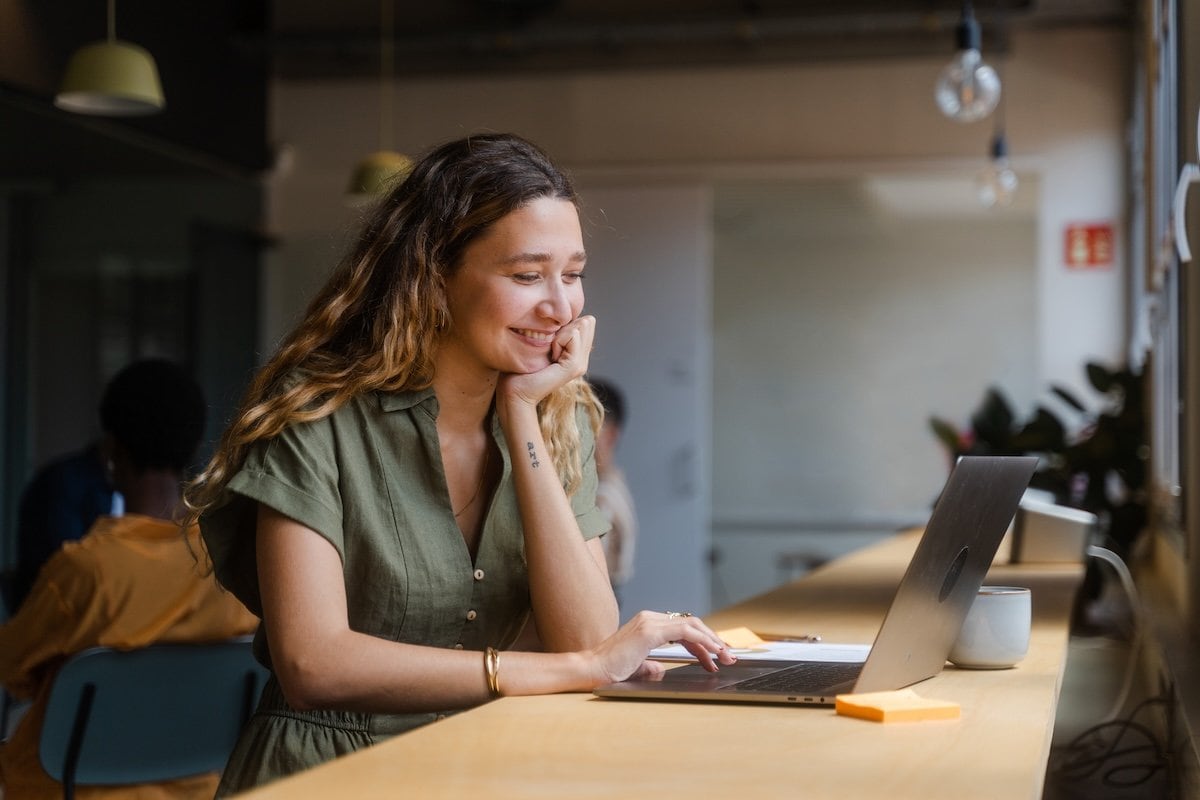 A person sitting at a desk with a laptop.