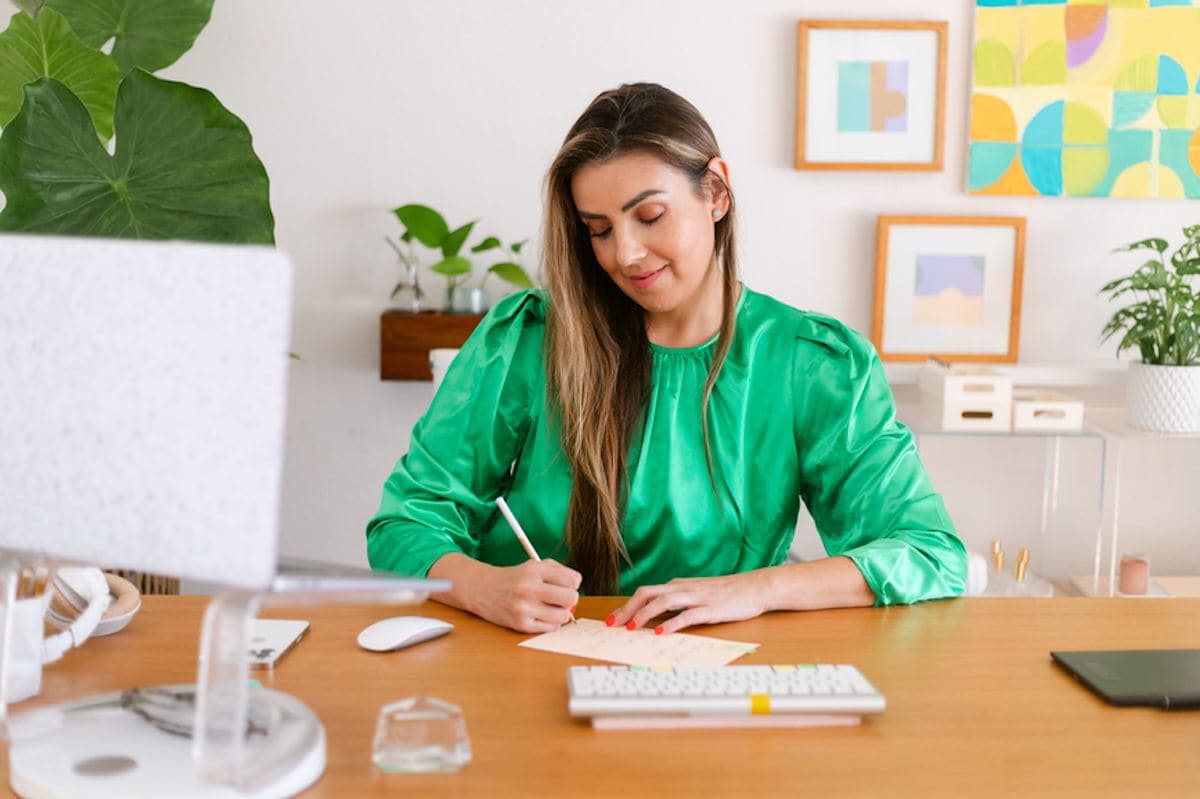 A person sitting at a table with a pen and paper.