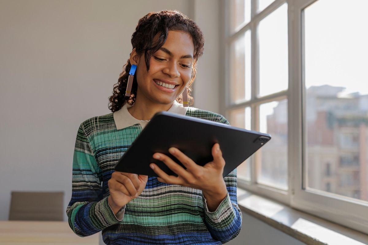 A person holding a laptop computer in her hands.