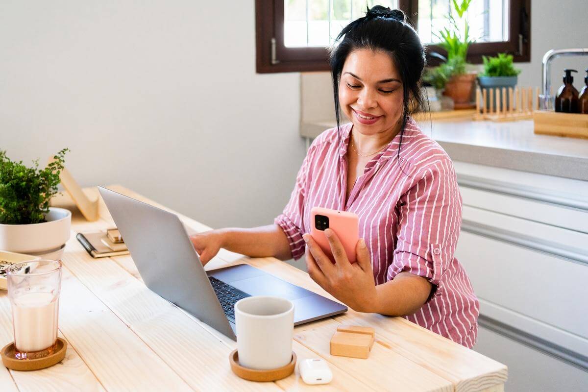 A person sitting at a desk with a laptop computer.