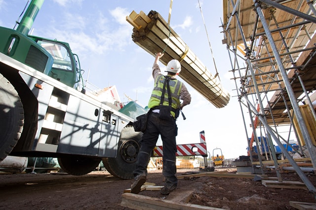 Construction scene with lumber being lifted