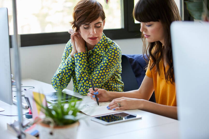 business women discussing a diagram at a desk