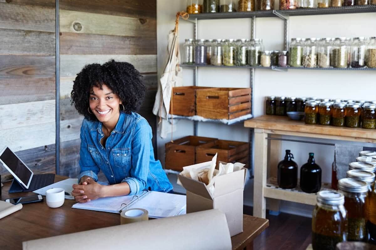A female business owner smiles in her studio.