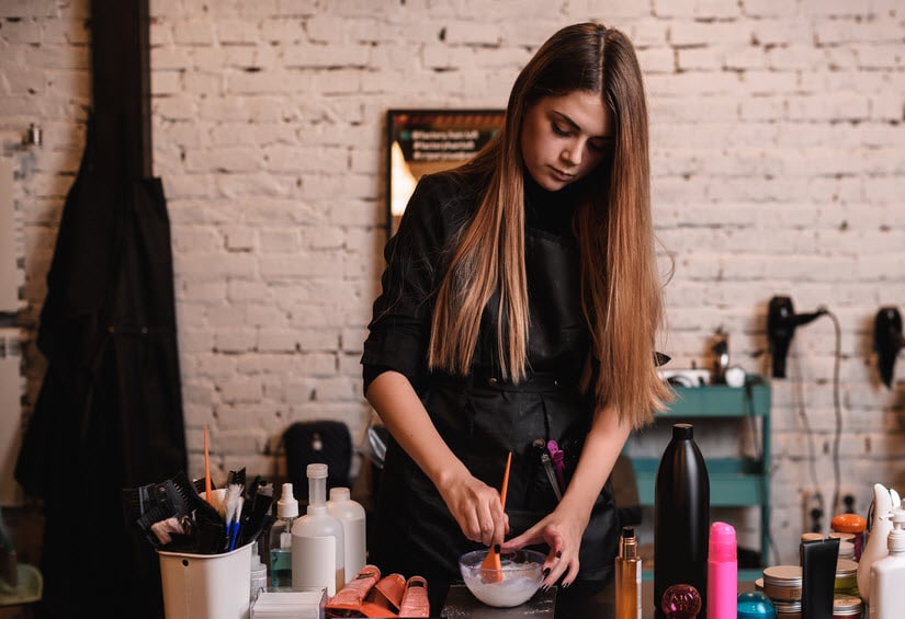 Hairdresser mixing colors for a client