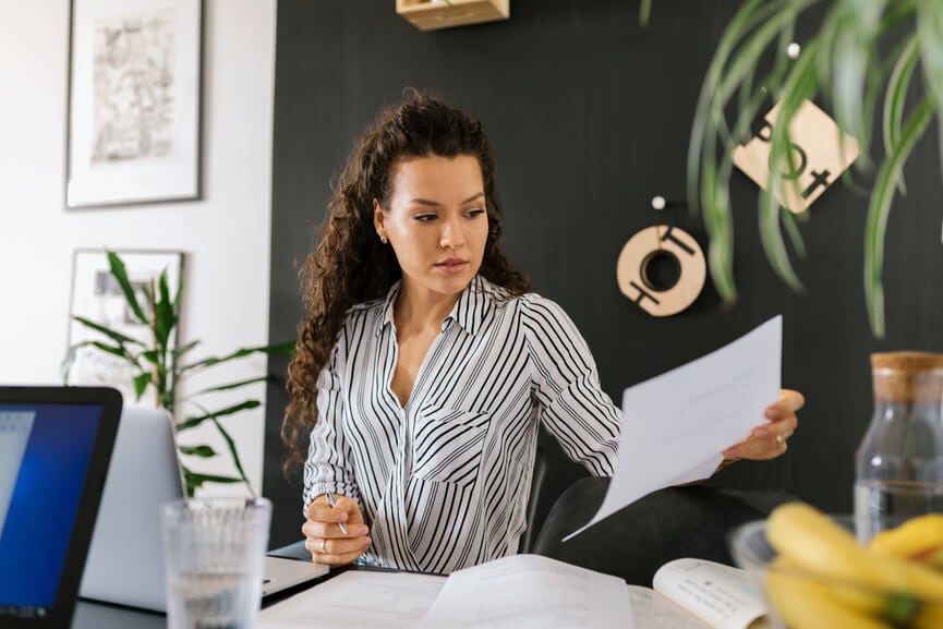 Woman reading her 1099-MISC to file taxes