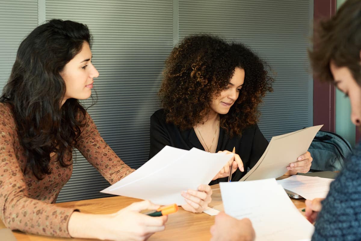 A group of freelancers collaborates at a table.